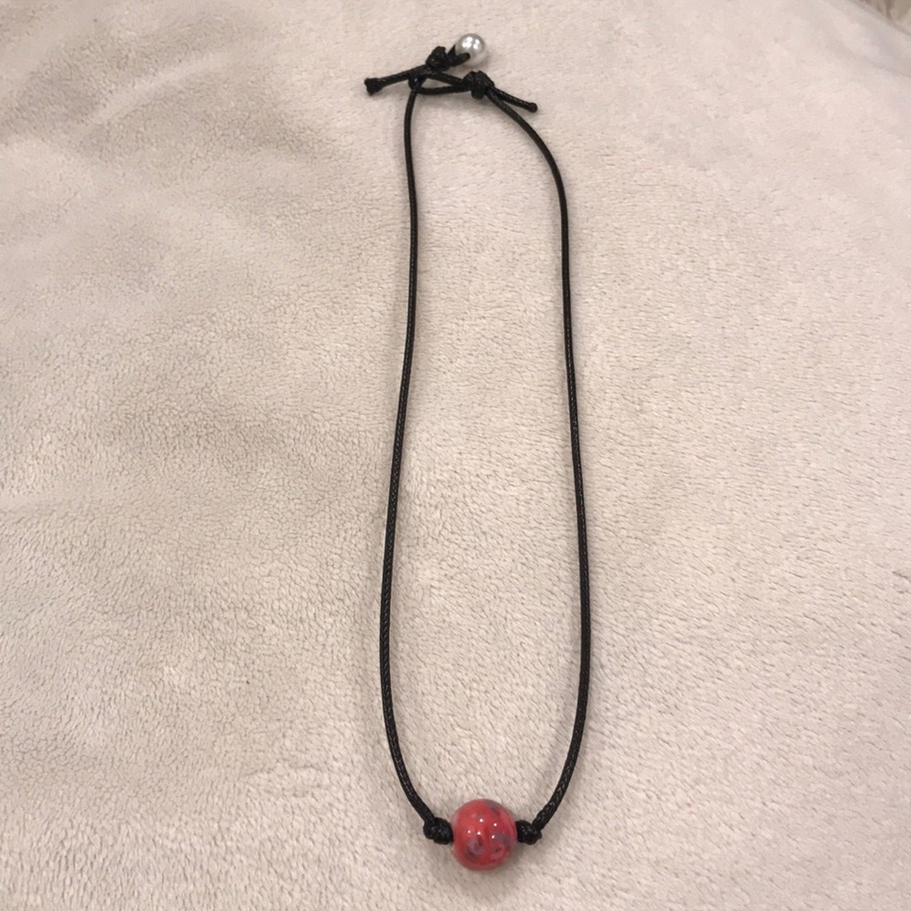 Choker necklace with a red ball